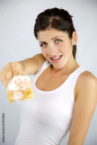 Female model smiling offering croissant © fabianaponzi