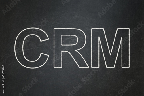 Business concept: CRM on chalkboard background