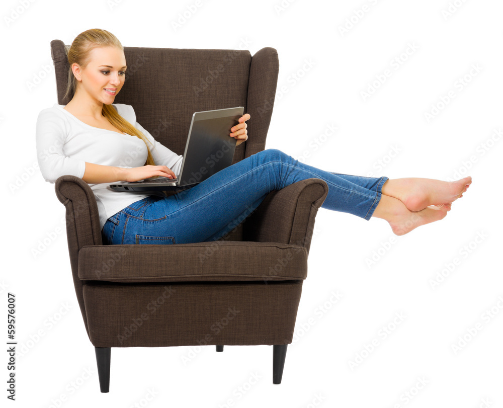 Young girl with laptop in chair Young girl with laptop in chair