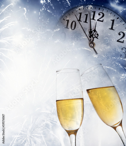 champagne glasses and clock at midnight