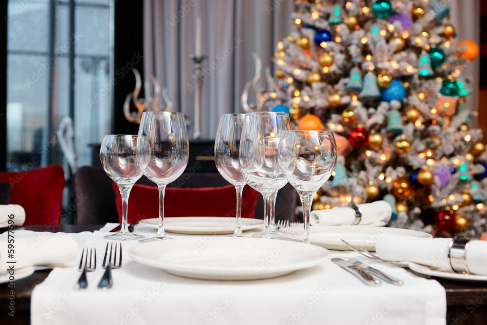 Place setting with Christmas tree in background