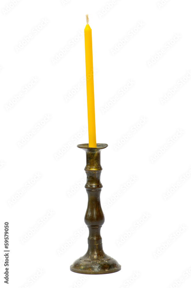 Old golden holder with yellow candle isolaated on white backgrou Old golden holder with yellow candle isolaated on white backgrou