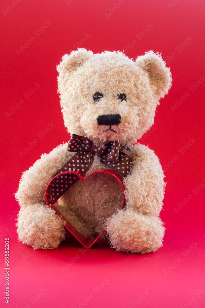 Cute teddy bear holding a heart Cute teddy bear holding a heart
