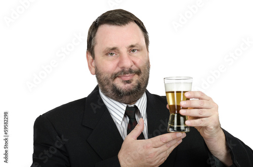 Bearded man in black suit holds lager glass