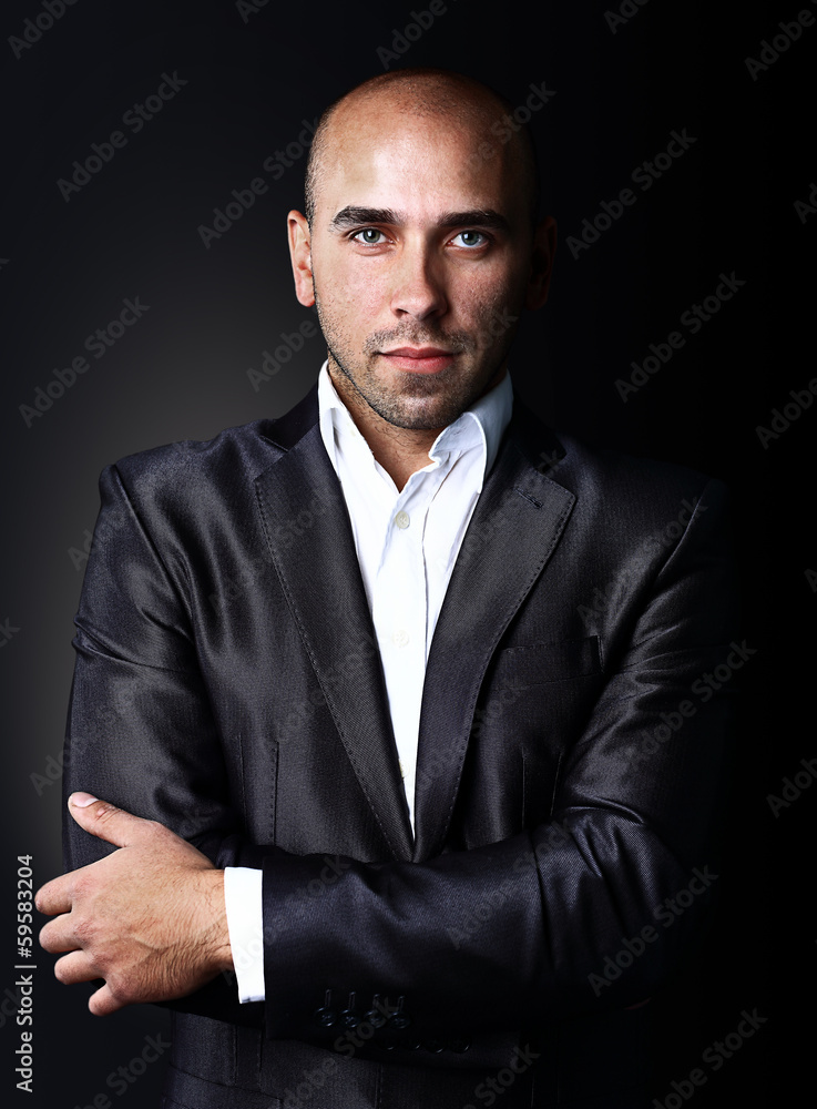 Cool businessman standing on dark gradient background Cool businessman standing on dark gradient background