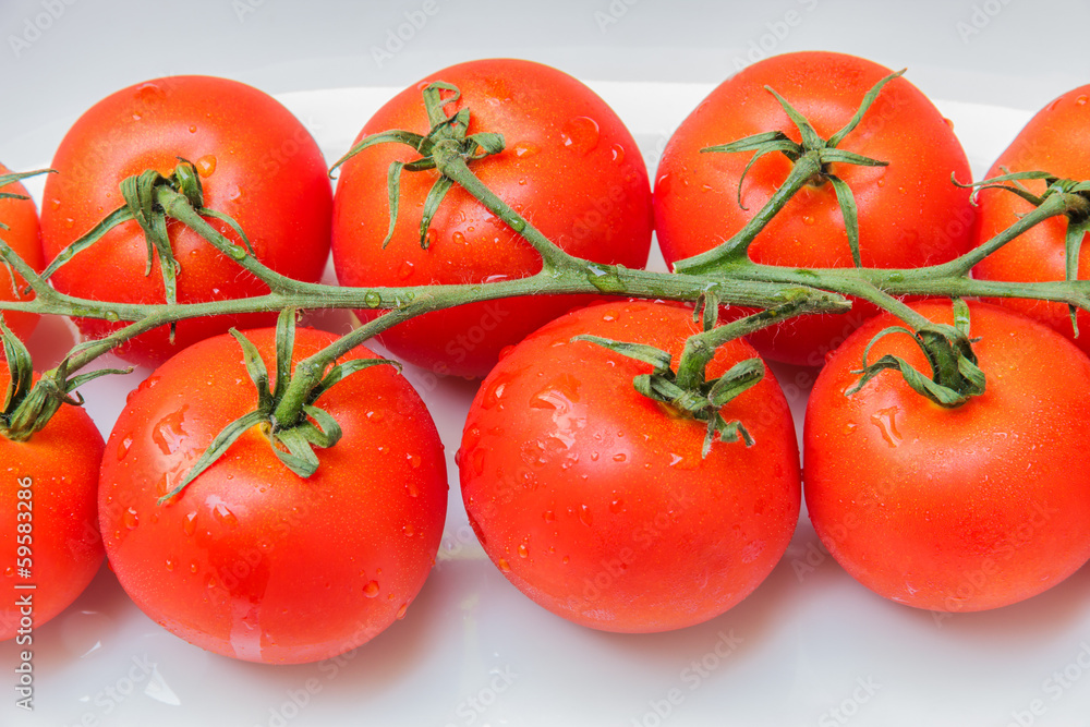Cherry tomatoes in a dish on a table made of wood. Cherry tomatoes in a dish on a table made of wood.
