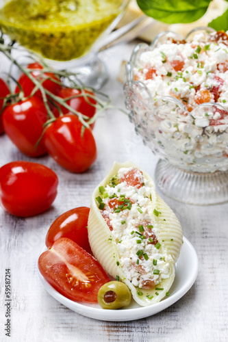 Italian cuisine: pasta shells stuffed with cottage and tomato