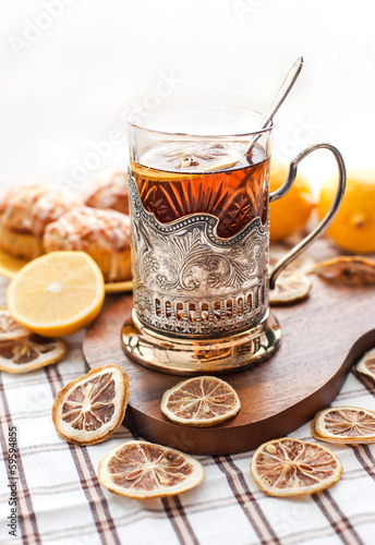 Black tea with lemon in the silver glass-holder