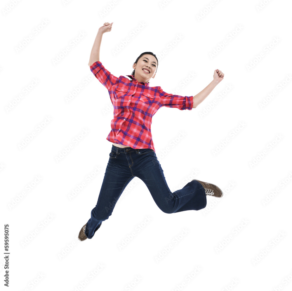 happy young woman jumping with arms extended happy young woman jumping with arms extended
