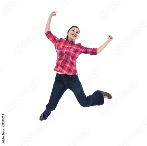 happy young woman jumping with arms extended