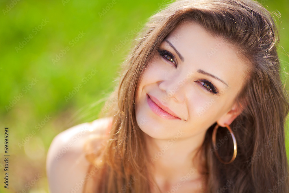 Portrait of a woman in red on a background of sky and grass Portrait of a woman in red on a background of sky and grass