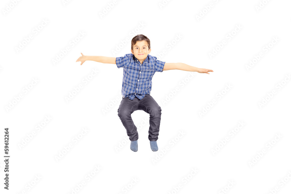 Smiling little boy jumping