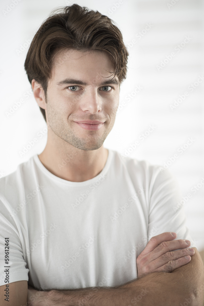 portrait of a handsome man with arms crossed portrait of a handsome man with arms crossed
