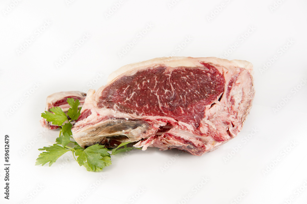 A fresh rib eye steak isolated on white background