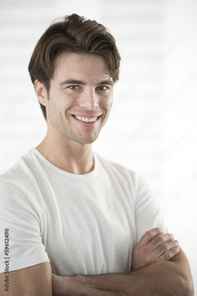 portrait of a handsome man with arms crossed portrait of a handsome man with arms crossed