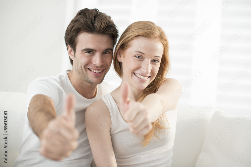 young happy couple showing ok young happy couple showing ok