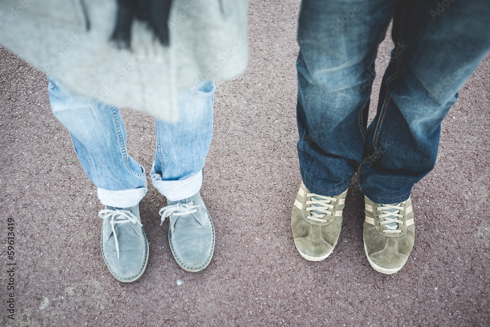 particular of legs and shoes of couple in love particular of legs and shoes of couple in love