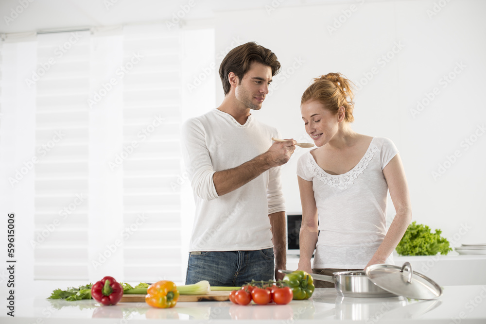 couple in the kitchen cooking vegetables couple in the kitchen cooking vegetables