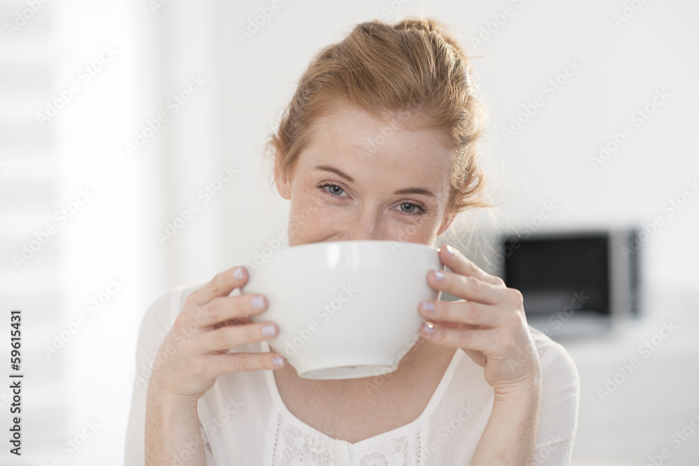 closeup young woman drinks in a big mug at breakfast closeup young woman drinks in a big mug at breakfast