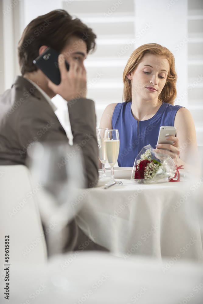 romantic couple bored together at restaurant romantic couple bored together at restaurant