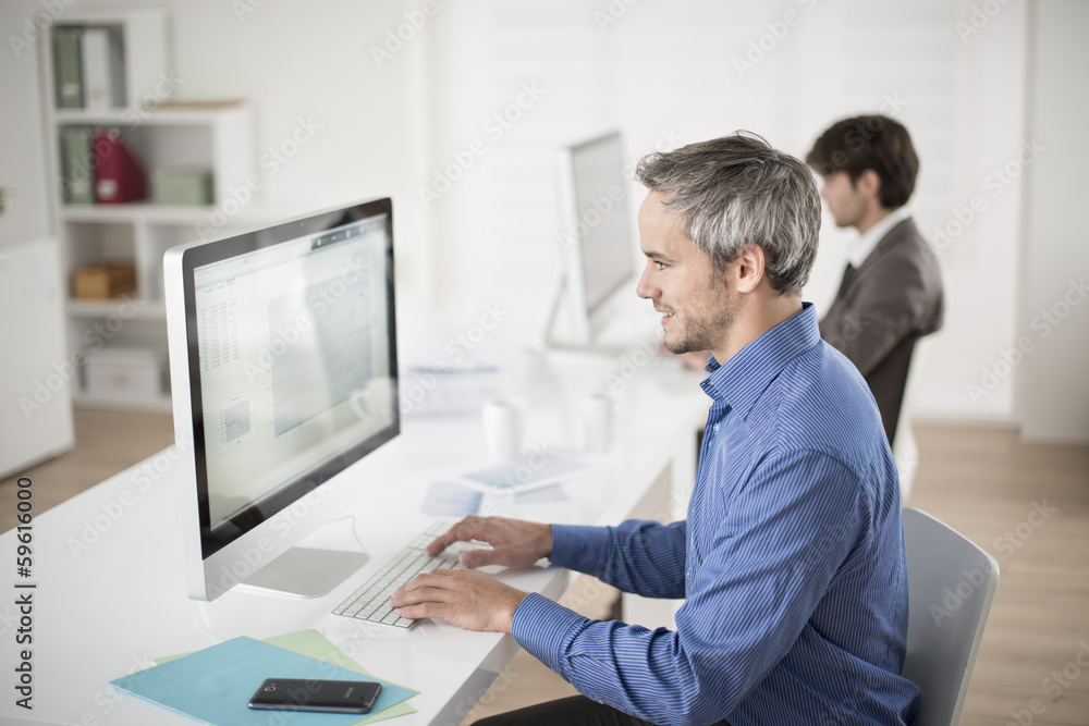 businessman works on computer at his office businessman works on computer at his office