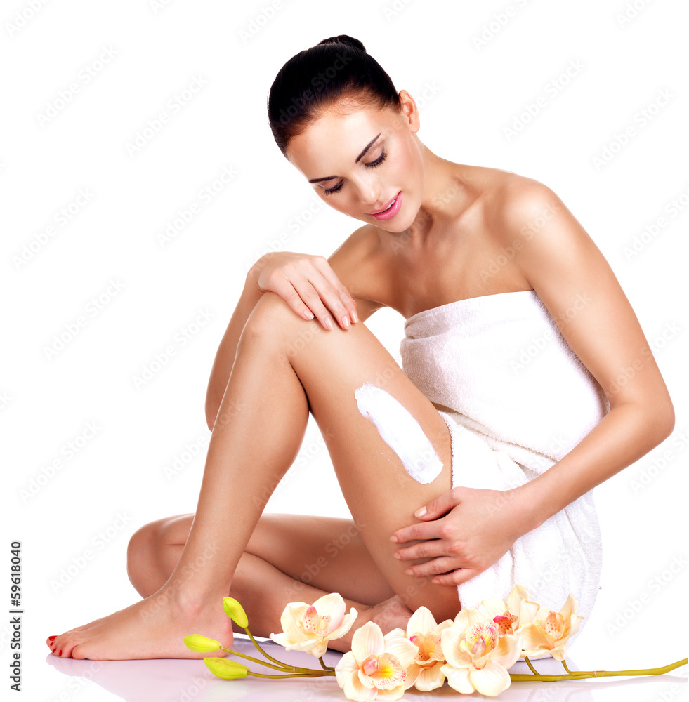 Beautiful young woman using cream. Beautiful young woman using cream.