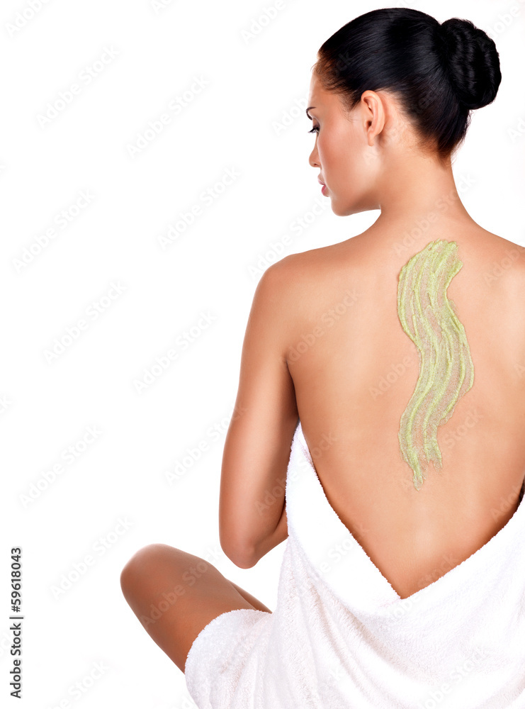 Fototapeta premium woman cares about skin of body using cosmetic scrub on the back