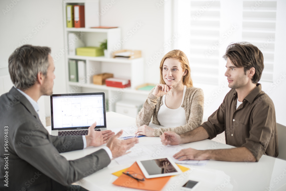 real-estate agent receives a young couple interested to invest i real-estate agent receives a young couple interested to invest i