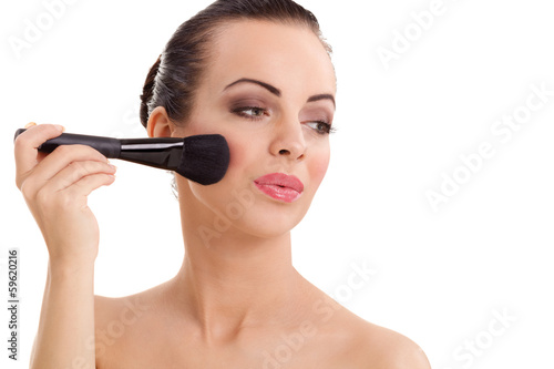 Portrait of the beautiful woman with make-up brushes