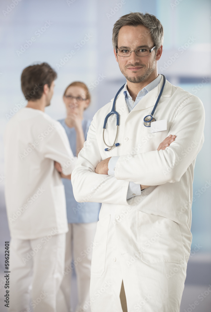 portrait of a doctor arms crossed in hospital portrait of a doctor arms crossed in hospital