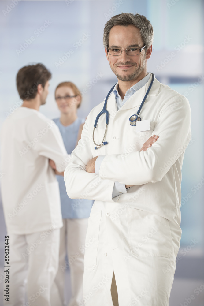 portrait of a doctor arms crossed in hospital portrait of a doctor arms crossed in hospital
