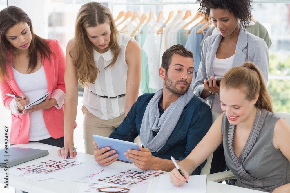 Fashion designers discussing designs Fashion designers discussing designs