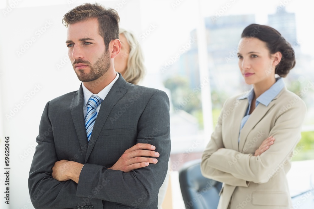 Confident and serious business team with arms crossed Confident and serious business team with arms crossed