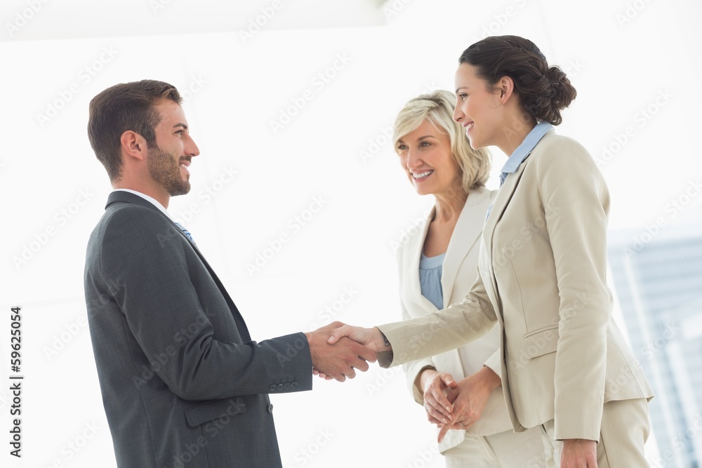 Executives shaking hands after a business meeting Executives shaking hands after a business meeting