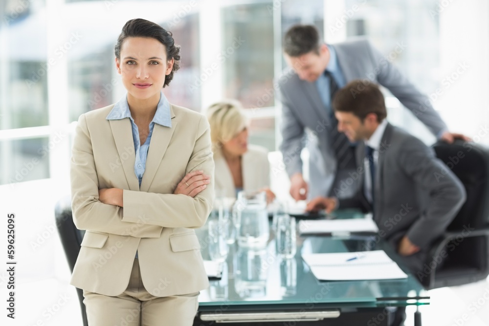 Fototapeta premium Businesswoman with colleagues discussing in office