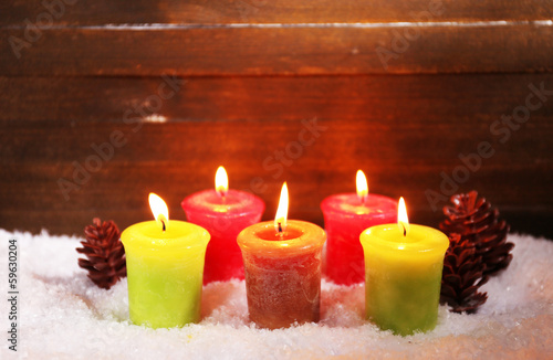 Burning candles on wooden background