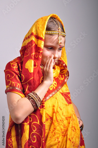 little girl in traditional Indian clothing dancing