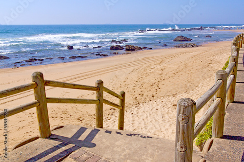 Stairway With Wooden Handrail Leading Onto Beach
