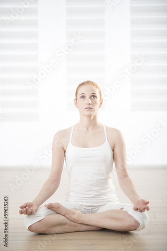 young woman practicing exercises easing