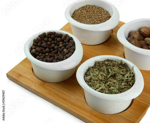 Assortment of spices in white bowls,