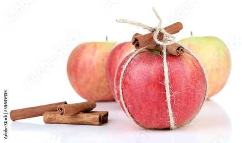 Ripe apple with with cinnamon sticks isolated on white