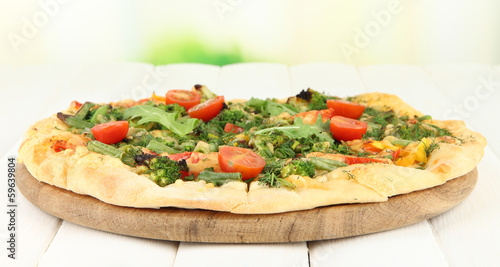 Tasty vegetarian pizza on wooden table