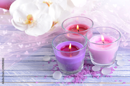 Beautiful colorful candles and orchid flowers,