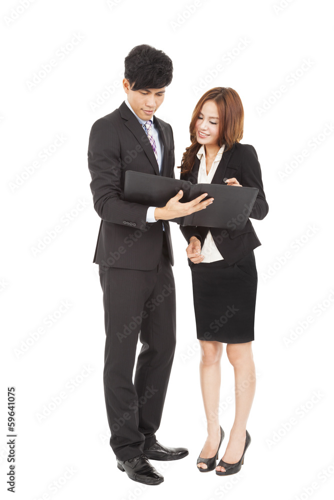 Business people standing and reading document together Business people standing and reading document together