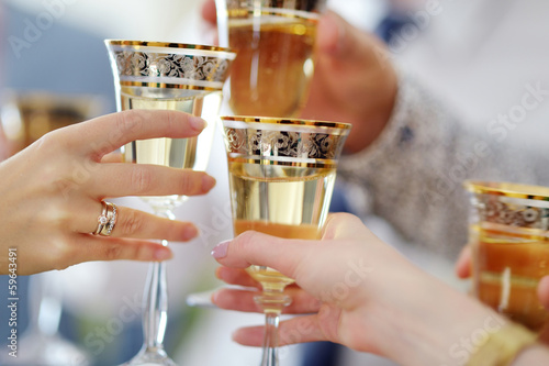 People holding wine glasses at festive event