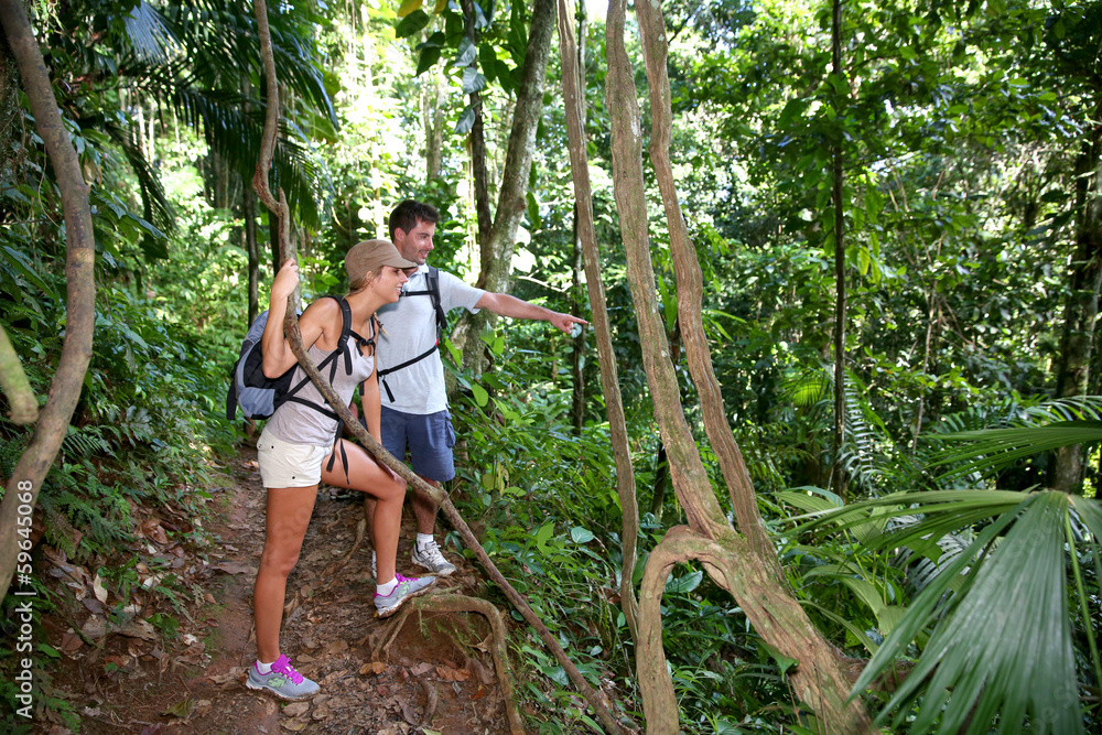 Couple on a trekking day in tropical forest Couple on a trekking day in tropical forest