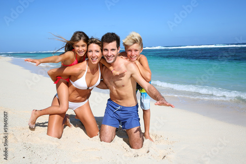 Family of four having fun at the beach