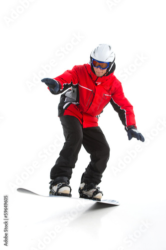 Full length shoot of Skillful male snowboarder jumping.