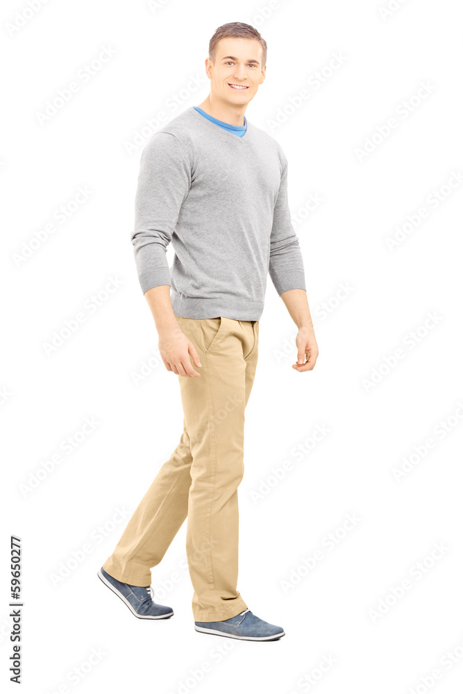 Full length portrait of a confident casual guy walking and looki Full length portrait of a confident casual guy walking and looki