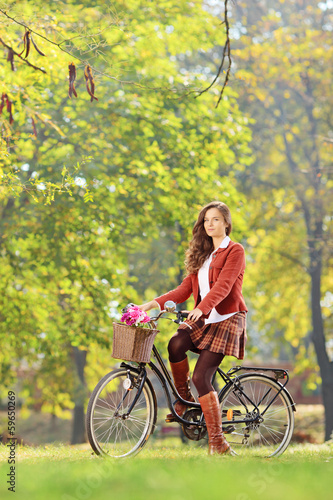 Beautiful female on a bicycle in a park